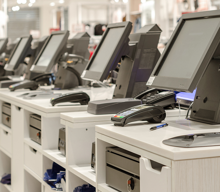 A line of Clothing store registers with payment consoles