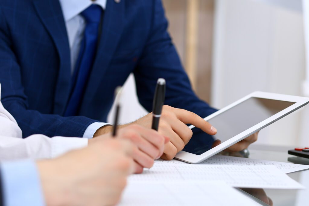 Bookkeepers team or financial inspectors making report, calculating and checking balance. Tax service financial document. Audit or meeting concept